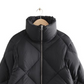 Jaqueta Puffer de penas e outras histórias em preto, tamanho médio
